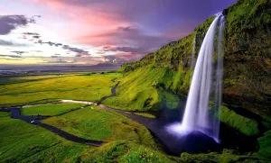 a waterfall in a green valley in Iceland